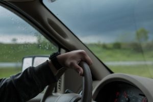 driver gripping steering wheel